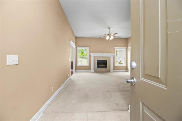 1111 SW 13th St, Oak Grove, MO 64075 - unfurnished living room with a ceiling fan, light carpet, and a fireplace