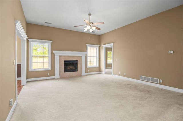 1111 SW 13th St, Oak Grove, MO 64075 - unfurnished living room featuring a ceiling fan, light carpet, a fireplace, and plenty of natural light
