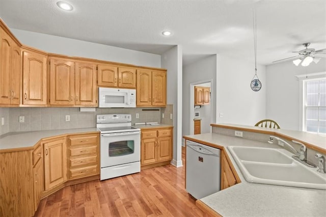 1111 SW 13th St, Oak Grove, MO 64075 - kitchen featuring white appliances, light countertops, light wood-style floors, decorative backsplash, and a ceiling fan