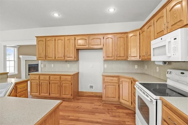 1111 SW 13th St, Oak Grove, MO 64075 - kitchen with white appliances, light wood-style floors, light countertops, decorative backsplash, and recessed lighting