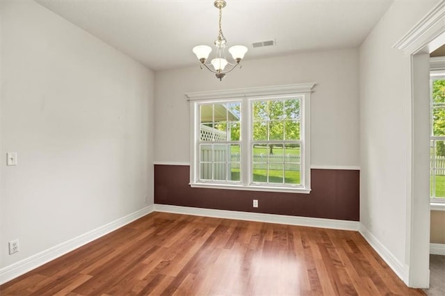 1111 SW 13th St, Oak Grove, MO 64075 - spare room featuring a chandelier, healthy amount of natural light, and wood finished floors