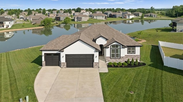 1104 SW Magnolia Cir, Oak Grove, MO 64075 - view of front facade featuring stone siding, an attached garage, a water view, stucco siding, and driveway