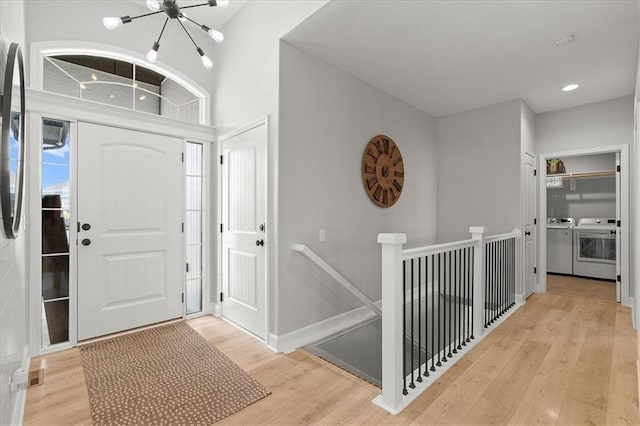 1104 SW Magnolia Cir, Oak Grove, MO 64075 - foyer entrance featuring washer and clothes dryer, a chandelier, light wood-style flooring, and recessed lighting