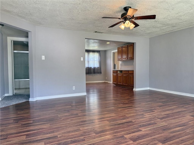 1514 Bryan St, Chillicothe, MO 64601 - unfurnished living room with ceiling fan, a textured ceiling, and dark wood-style floors