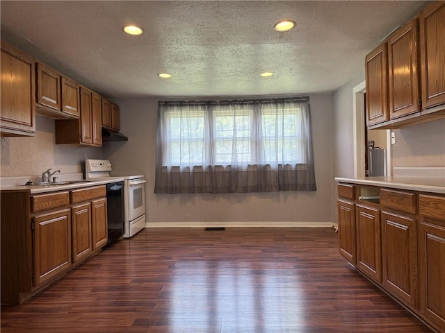 1514 Bryan St, Chillicothe, MO 64601 - kitchen with electric stove, under cabinet range hood, light countertops, plenty of natural light, and a textured ceiling