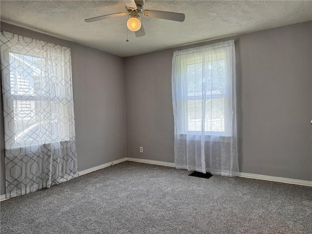 1514 Bryan St, Chillicothe, MO 64601 - empty room with a textured ceiling, carpet flooring, and ceiling fan