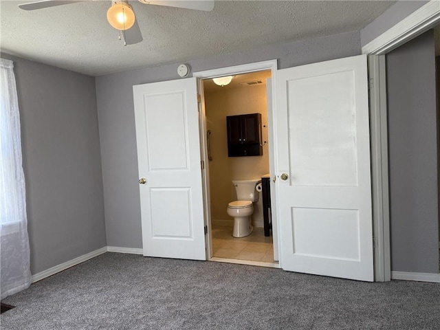 1514 Bryan St, Chillicothe, MO 64601 - unfurnished bedroom with carpet, ensuite bath, a textured ceiling, and a ceiling fan