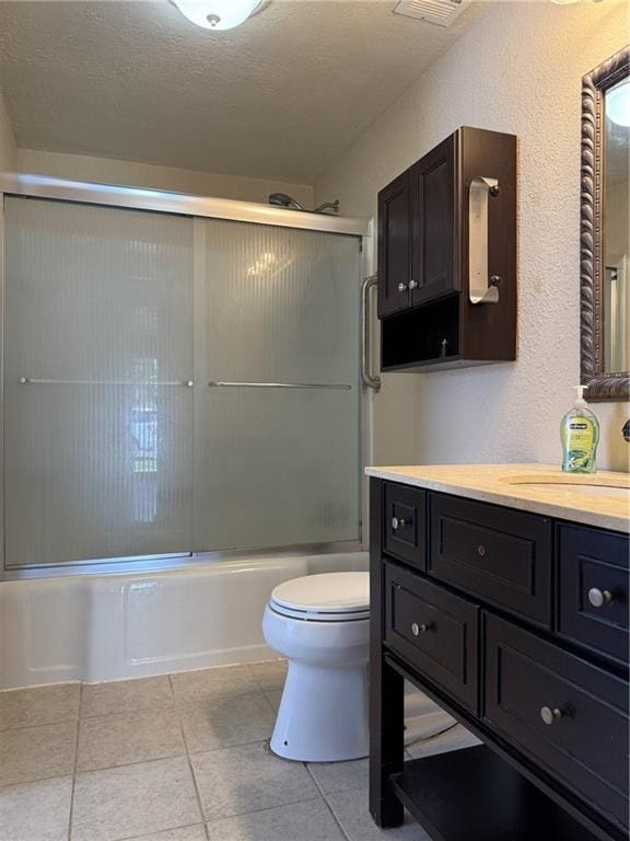 1514 Bryan St, Chillicothe, MO 64601 - bathroom with vanity, tile patterned floors, enclosed tub / shower combo, and a textured ceiling