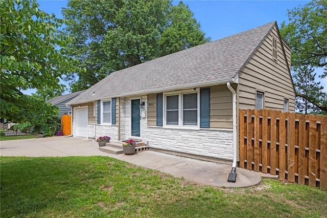 5011 Briar St, Roeland Park, KS 66205 - ranch-style home featuring stone siding, roof with shingles, a garage, and concrete driveway