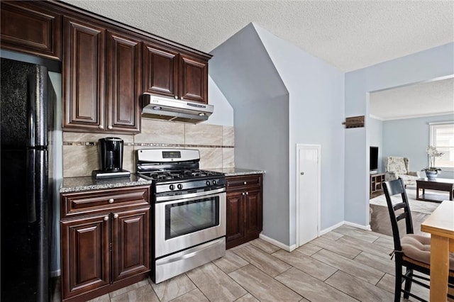 5011 Briar St, Roeland Park, KS 66205 - kitchen with stainless steel gas stove, freestanding refrigerator, under cabinet range hood, tasteful backsplash, and dark brown cabinets
