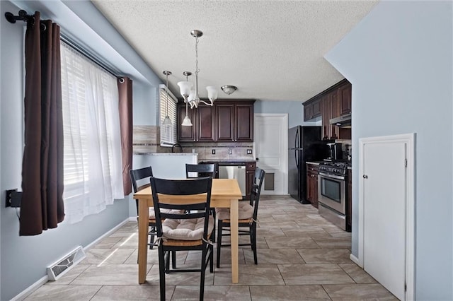 5011 Briar St, Roeland Park, KS 66205 - dining room featuring plenty of natural light, a chandelier, and a textured ceiling