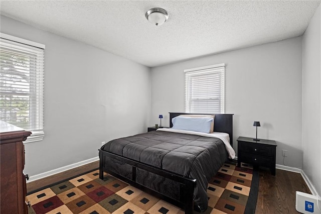 5011 Briar St, Roeland Park, KS 66205 - bedroom featuring wood finished floors, multiple windows, and a textured ceiling