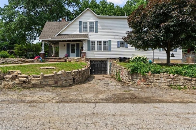 402 Fifth St, Smithville, MO 64089 - view of front facade featuring a garage, a porch, driveway, and a chimney
