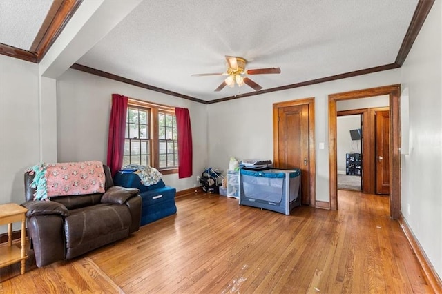 402 Fifth St, Smithville, MO 64089 - sitting room with light wood-style flooring, ornamental molding, a ceiling fan, and a textured ceiling