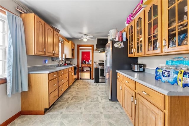 402 Fifth St, Smithville, MO 64089 - kitchen with a ceiling fan, light countertops, glass insert cabinets, and freestanding refrigerator
