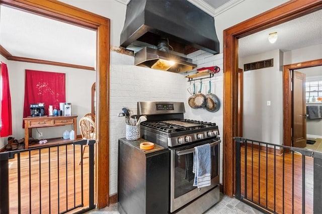 402 Fifth St, Smithville, MO 64089 - kitchen with stainless steel gas range oven, extractor fan, ornamental molding, and tasteful backsplash