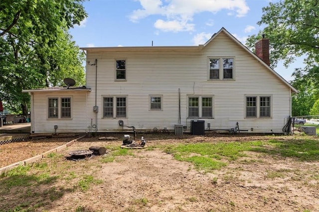 402 Fifth St, Smithville, MO 64089 - rear view of property with a chimney