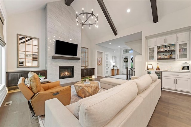 11807 S Kenton St, Olathe, KS 66061 - living room featuring bar, high vaulted ceiling, dark wood-style flooring, beam ceiling, and a premium fireplace