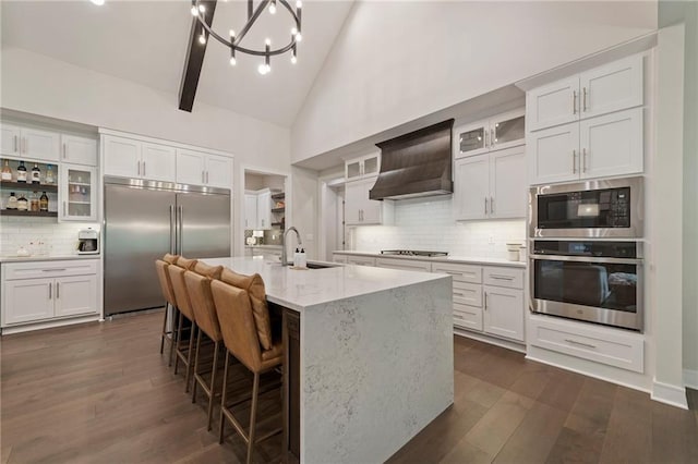 11807 S Kenton St, Olathe, KS 66061 - kitchen with built in appliances, open shelves, backsplash, custom exhaust hood, and high vaulted ceiling