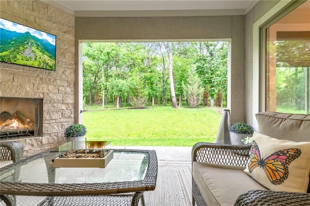 11807 S Kenton St, Olathe, KS 66061 - sunroom featuring an outdoor living space with a fireplace and view of scattered trees