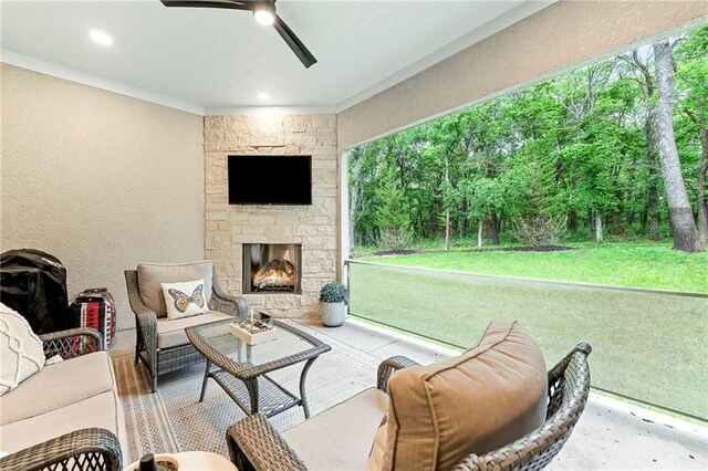 11807 S Kenton St, Olathe, KS 66061 - living room featuring ceiling fan, a textured wall, a stone fireplace, and crown molding