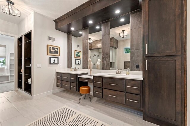 11807 S Kenton St, Olathe, KS 66061 - bathroom with two vanities, tile patterned floors, walk in shower, and built in shelves