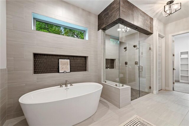 11807 S Kenton St, Olathe, KS 66061 - full bath featuring a freestanding tub, a shower stall, and tile walls