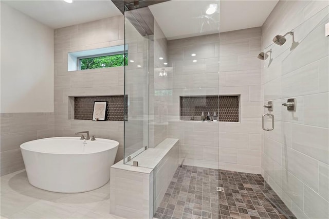 11807 S Kenton St, Olathe, KS 66061 - full bathroom featuring a stall shower, a soaking tub, tile walls, and a fireplace