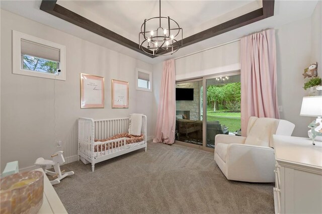 11807 S Kenton St, Olathe, KS 66061 - carpeted bedroom with a chandelier, a fireplace, and access to outside