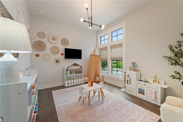 11807 S Kenton St, Olathe, KS 66061 - recreation room featuring a chandelier and dark wood finished floors