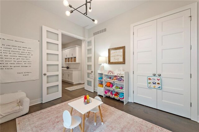 11807 S Kenton St, Olathe, KS 66061 - recreation room with a chandelier, dark wood-style floors, and french doors
