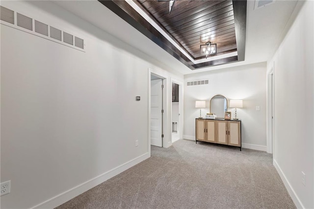 11807 S Kenton St, Olathe, KS 66061 - unfurnished bedroom with a raised ceiling, carpet, and wood ceiling