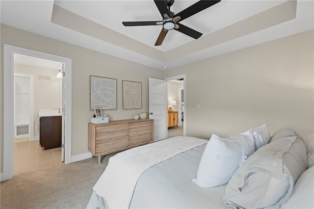 11807 S Kenton St, Olathe, KS 66061 - bedroom with a raised ceiling, light colored carpet, connected bathroom, and a ceiling fan