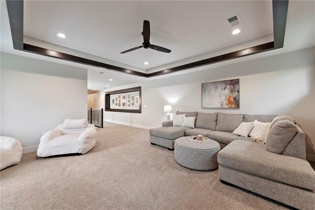 11807 S Kenton St, Olathe, KS 66061 - carpeted living room with a tray ceiling, recessed lighting, and ceiling fan