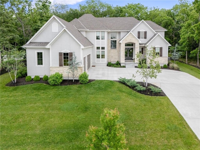 11807 S Kenton St, Olathe, KS 66061 - view of front of home featuring driveway, a front yard, roof with shingles, and stucco siding