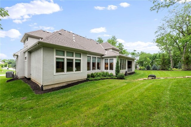 11807 S Kenton St, Olathe, KS 66061 - back of property featuring a yard, roof with shingles, and stucco siding