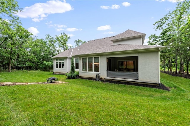 11807 S Kenton St, Olathe, KS 66061 - back of house with a lawn, a fire pit, and stucco siding