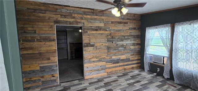 2251 Nemaha Rd, Cummings, KS 66016 - detailed view of wood walls, a ceiling fan, wood finished floors, cooling unit, and a textured ceiling