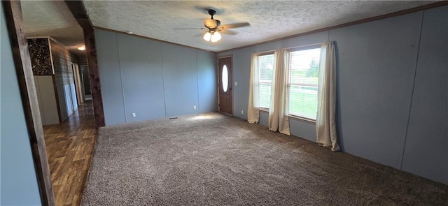 2251 Nemaha Rd, Cummings, KS 66016 - spare room featuring crown molding, ceiling fan, a textured ceiling, and dark carpet