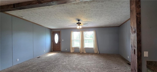 2251 Nemaha Rd, Cummings, KS 66016 - entryway featuring ceiling fan, crown molding, carpet floors, a decorative wall, and a textured ceiling