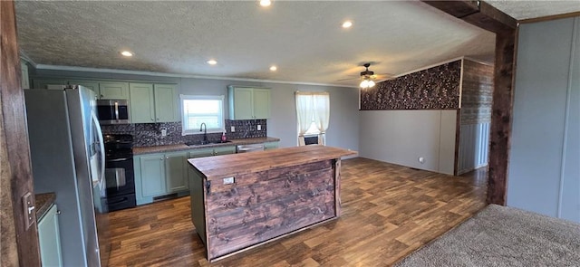 2251 Nemaha Rd, Cummings, KS 66016 - kitchen with appliances with stainless steel finishes, ornamental molding, green cabinets, dark wood finished floors, and a ceiling fan