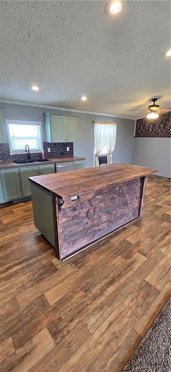2251 Nemaha Rd, Cummings, KS 66016 - kitchen with a textured ceiling, dark wood-type flooring, decorative backsplash, recessed lighting, and green cabinetry