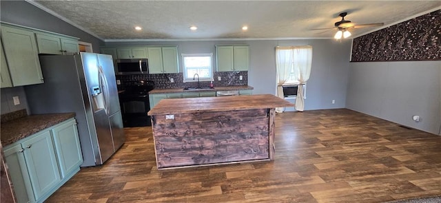 2251 Nemaha Rd, Cummings, KS 66016 - kitchen featuring stainless steel appliances, green cabinetry, ornamental molding, ceiling fan, and dark wood-type flooring