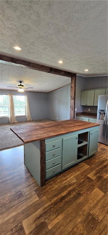 2251 Nemaha Rd, Cummings, KS 66016 - kitchen featuring butcher block counters, stainless steel fridge, a textured ceiling, dark wood-style floors, and recessed lighting