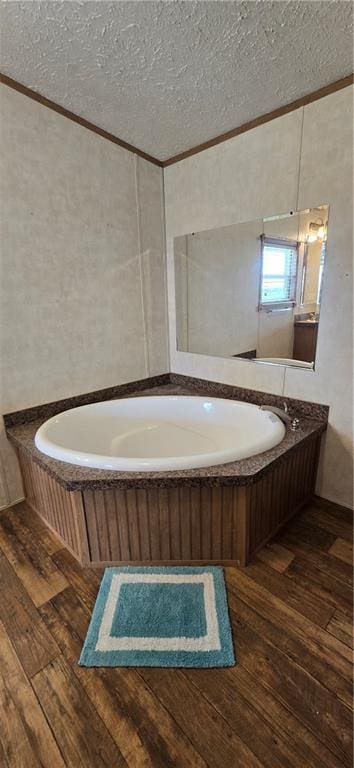 2251 Nemaha Rd, Cummings, KS 66016 - bathroom with hardwood / wood-style flooring, ornamental molding, a garden tub, and a textured ceiling