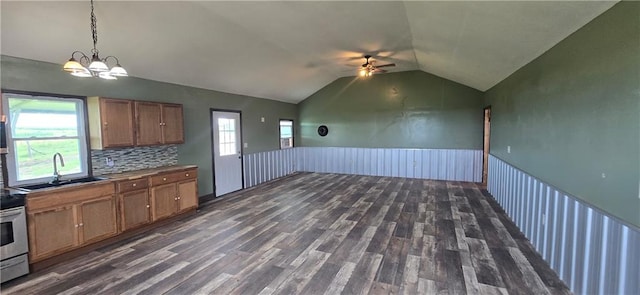 2251 Nemaha Rd, Cummings, KS 66016 - kitchen with ceiling fan, brown cabinetry, lofted ceiling, dark wood finished floors, and a wainscoted wall