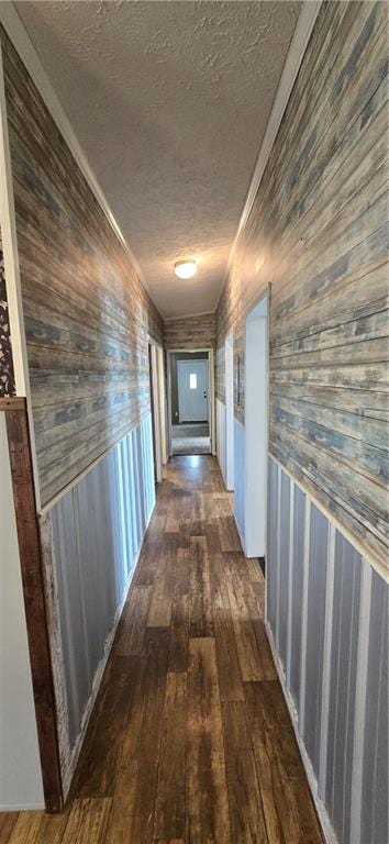 2251 Nemaha Rd, Cummings, KS 66016 - hall with a textured ceiling, dark wood-style flooring, wooden walls, and a wainscoted wall