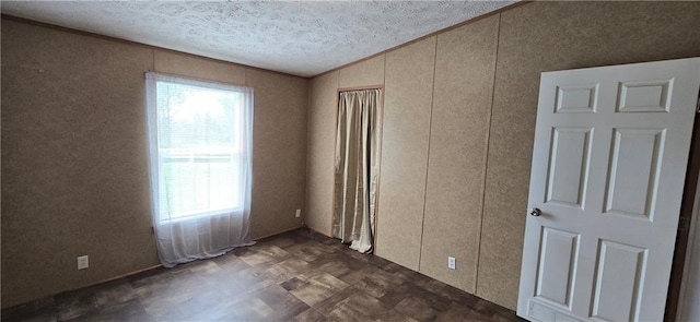 2251 Nemaha Rd, Cummings, KS 66016 - unfurnished bedroom with multiple windows, a decorative wall, a textured ceiling, and lofted ceiling