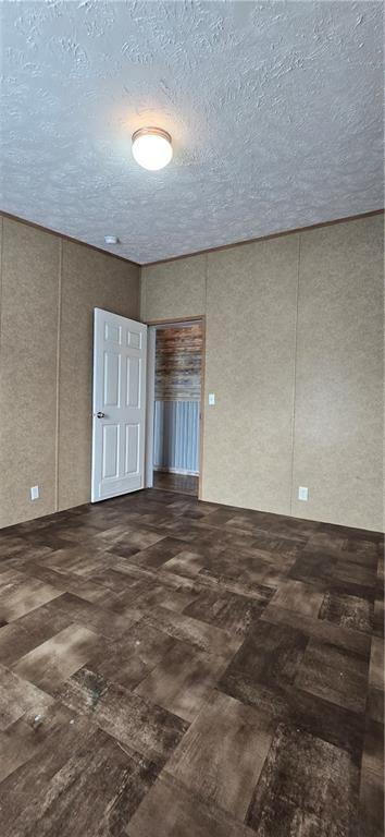 2251 Nemaha Rd, Cummings, KS 66016 - spare room with a decorative wall and a textured ceiling