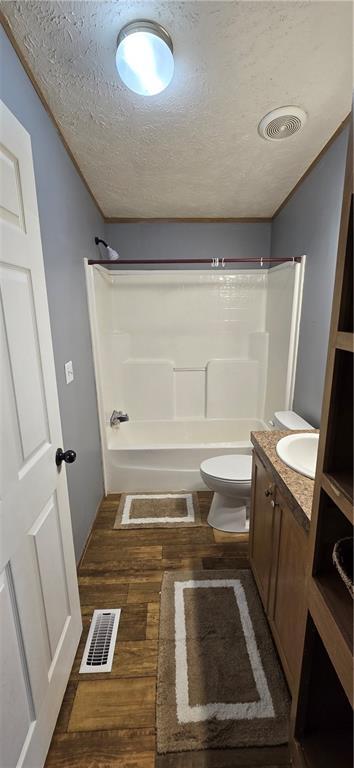 2251 Nemaha Rd, Cummings, KS 66016 - full bathroom featuring vanity, shower / bath combination, a textured ceiling, and wood finished floors
